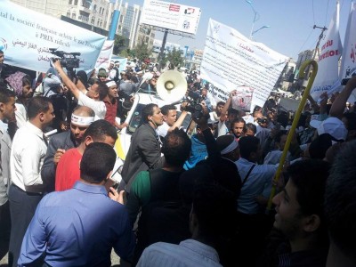 Protesters in the capital Sanaa marching and holding signs condemning Yemen's LNG sales agreement. 