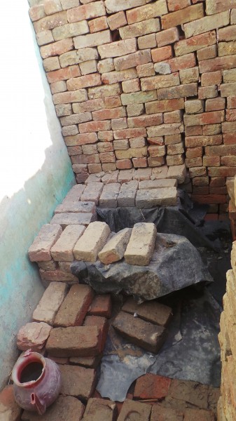 A traditional dry toilet in a village of Uttar Pradesh, India, that requires manual scavenging to clean. Image by author