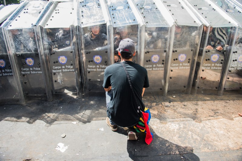 Students trying to persuade riot police in Caracas, Venezuela. Copyright Demotix. Photo by Carlos Becerra on 12 February 2014.