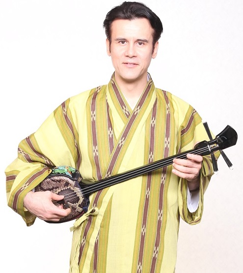 Fija Byron holding sanshin, Okinawan instrument (image used with permmisison)