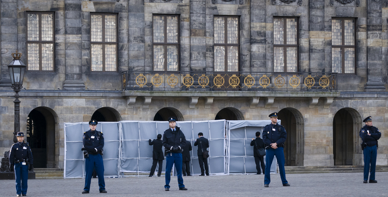 Shortly before the arrival of Chinese President Xi Jinping at the Royal Palace in Amsterdam on March 22, 2014, Chinese security officials erected screens to block the president's view of the protesters. Photo by Hans Knikman/Demotix.