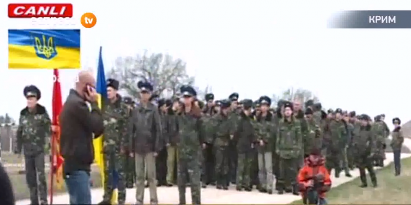 A column of unarmed Ukrainian soldiers confronts a militia checkpoint in the Crimea.