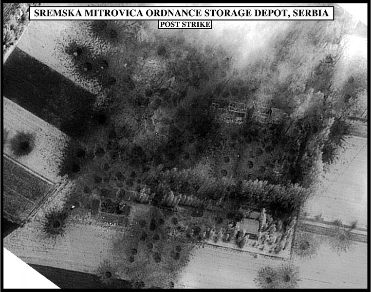 Post-strike bomb damage assessment photograph of the Sremska Mitrovica Ordnance Storage Depot, Serbia, used by Joint Staff Vice Director for Strategic Plans and Policy Maj. Gen. Charles F. Wald, U.S. Air Force, during a press briefing on NATO Operation Al. Image by United States Government, public domain. 