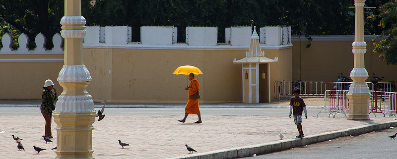 A monk walking in a community plaza