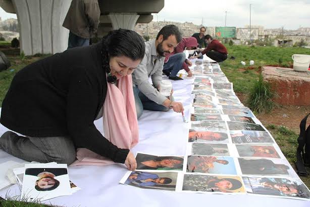 Marcell and friends preparing the martyrs memorial to commemorate the third anniversary of the Syrian revolution 