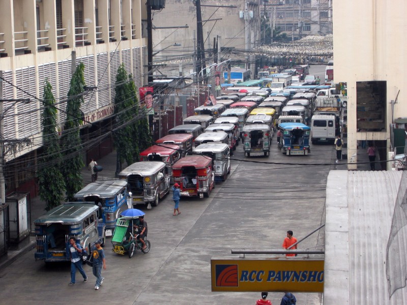 A daily scene in downtown Manila where Jeepneys occupy all the lanes of a street. Flickr photo by Kahunapule Michael J (CC License)