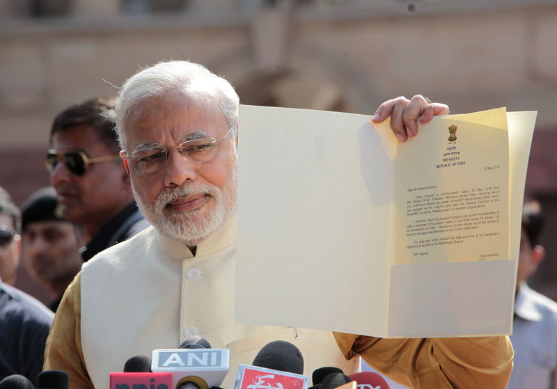 Narendra Modi talking to media showing the letter of President of India appointing him as Prime Minister of India. Image by Ranjan Basu. Copyright Demotix (20/5/2014)