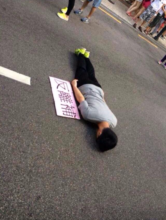 A young man staged the PK body posture against  the Greed Bill in the protest. PK posture is an bodily expression of absurdity among youngster in East Asia.] Photo posted by Facebook user Ar B Cheong. Non-commercial use. 
