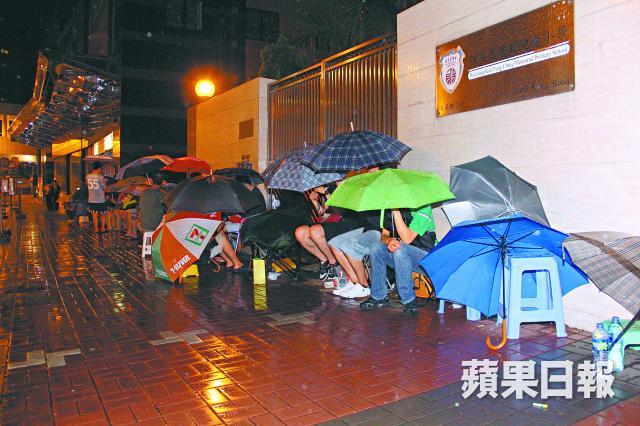 Parents waiting outside an international kindergarten in the rain to hand in application form for their kids. Photo from Apple Daily. Non-commercial use.