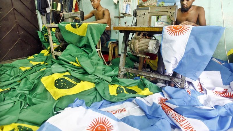 Tailors sew Brazil and Argentina flags at a shop in Dhaka ahead of the World Cup.  Image by Rohit Rajib. Copyright Demotix (21/5/2014)