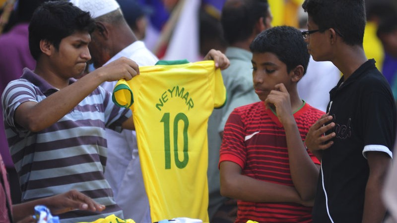 Bangladeshi Football fans are already busy buying flags and jerseys of the countries they support. Image by Firoz Ahmed. Copyright Demotix (