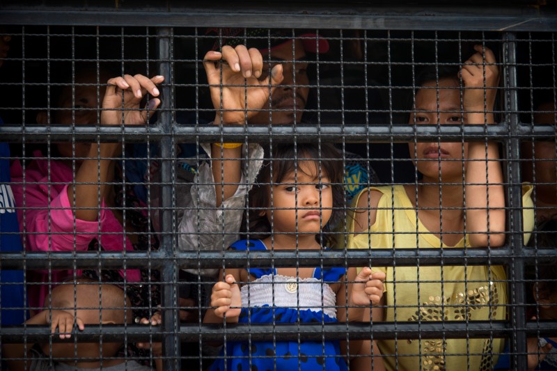 A Cambodian migrant family onboard a truck that will take them to the border where they will leave Thailand. Photo by Lee Craker, Copyright @Demotix (6/17/2014)