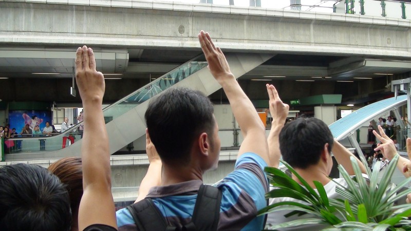 Anti Coup protesters raise their hands in a three finger salute as a symbol of struggle. Photo by Gonzalo Abad, Copyright @Demotix (6/1/2014)