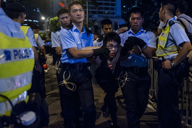 Police arrest a protester during a pro-democracy sit-in in Hong Kong on July 1, 2014. Photo by Xaume Olleros. Copyright Demotix