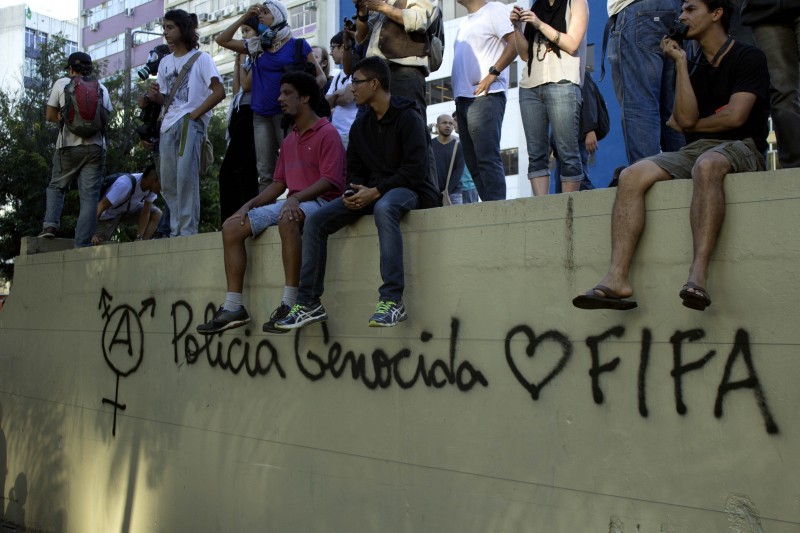 Graffiti on the walls in Barra da Tijuca in Rio de Janeiro reads "Genocidal police loves FIFA." 13 July 2014. Photo by Shay Horse. Copyright Demotix