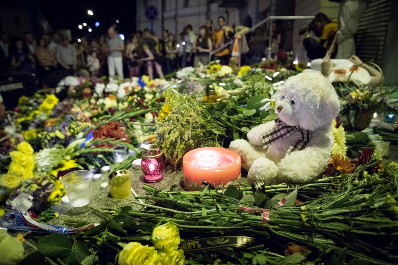 Ukrainians bring flowers, candles and toys to the entrance of the Dutch Embassy in Kiev on June 17, 2014. Malaysian Airlines airliner MH17 Amsterdam - Kuala Lumpur was shot down earlier in the day. Photo by Oleksandr Ratushniak. Copyright Demotix
