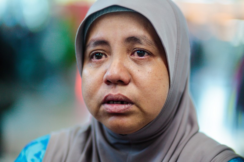 A relative of those on board flight MH17 getting emotional while being interviewed by media. Photo by Hon Keong Soo. Copyright @Demotix (7/18/2014)