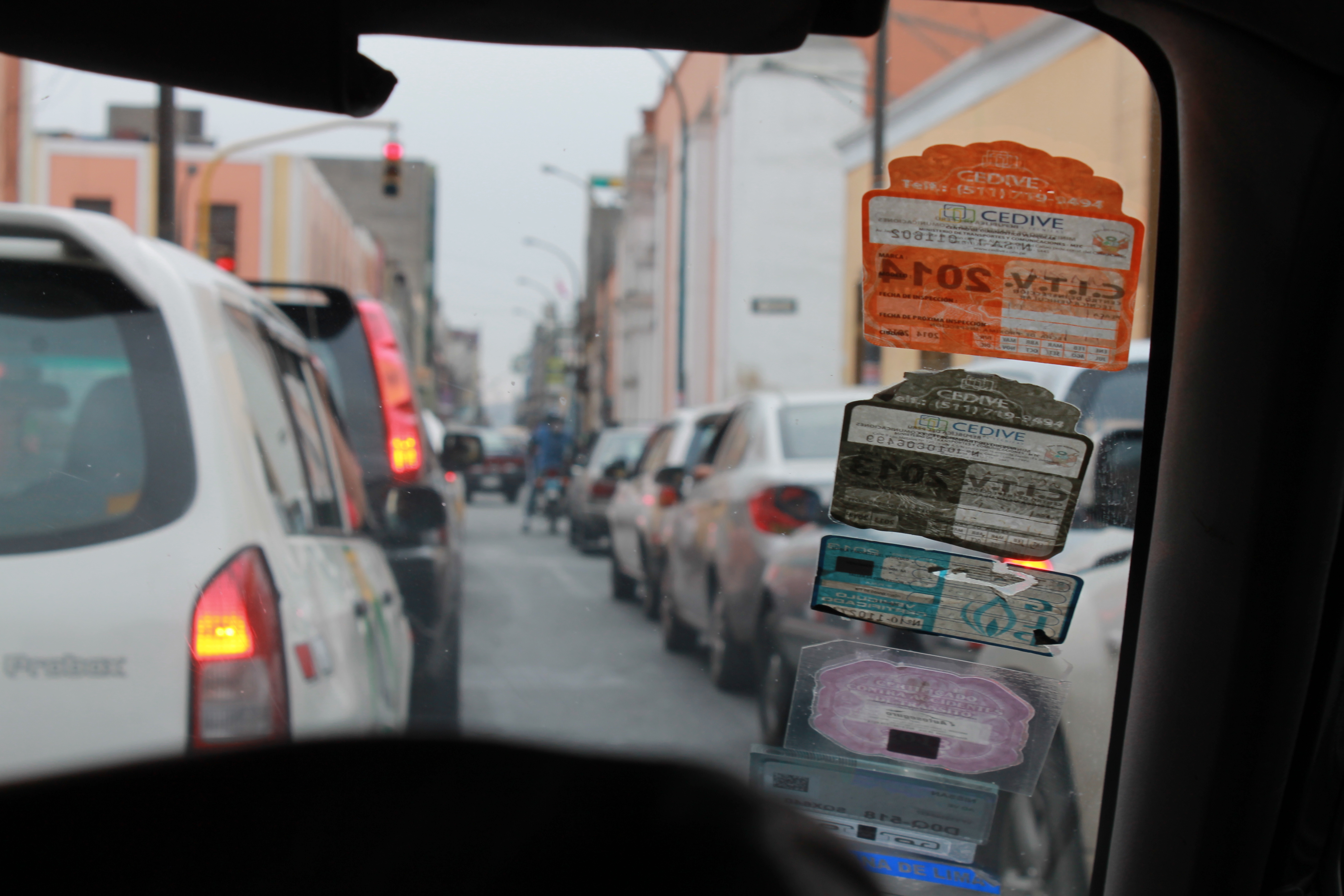 A taxi driver's accumulated yearly permits displayed on his windscreen. Photo by Alex Pashley.