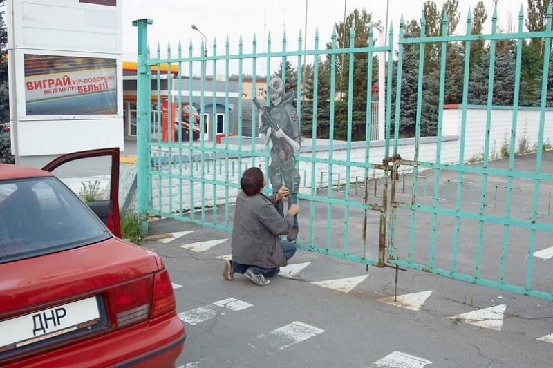 Zakharov himself, attaching an artwork to a fence in Donetsk in 2014. Image from Facebook.