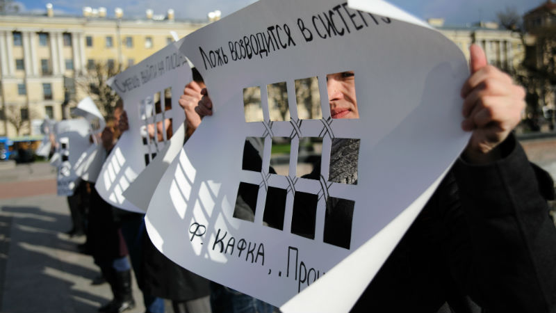 Participants of the picket in support of Bolotnaya Square prisoners in St. Petersburg hold banners in the form of prison bars. Photo by Denis Tarasov for Demotix.