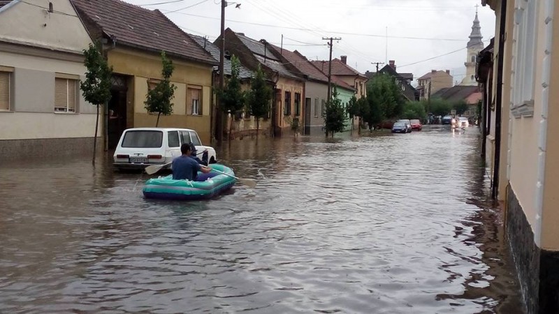 A man uses a boat to navigate the streets in Vršac, Serbia during a new wave of flooding in July 2014. Photos collected by Nenad Kiss from social media users, widely circulated online. 