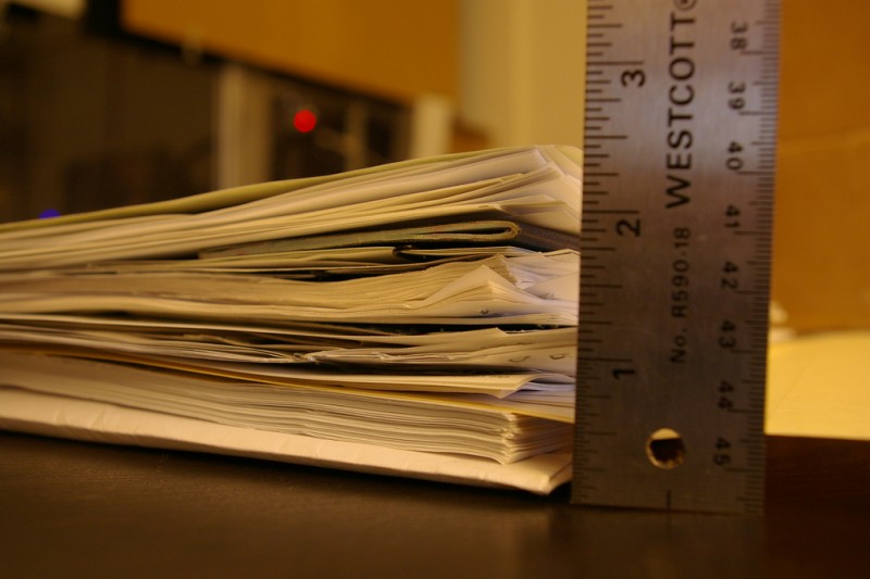 Stack of paperwork for US immigration. Image from Flickr by Stephanie Pakrul. CC BY-NC-SA 2.0