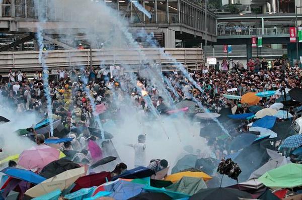 Hongkongští demonstranti používají deštníky, aby se chránili před slzným plynem. Fotografie z Twitteru, účet @15MBcn_int.