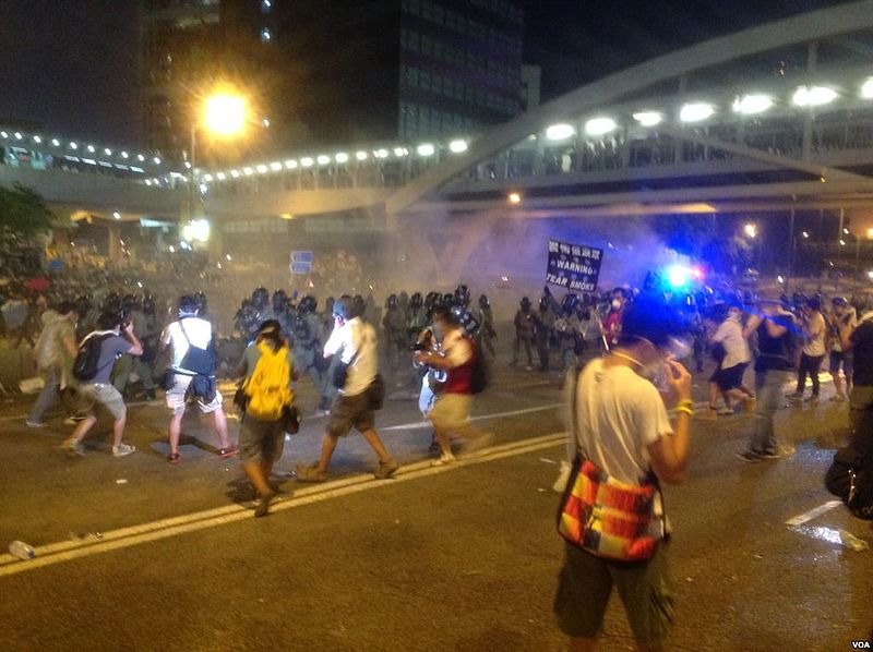 Protesters face tear gas in Hong Kong, Sept. 28, 2014. Photo by 海彥, released to public domain by Voice of America.
