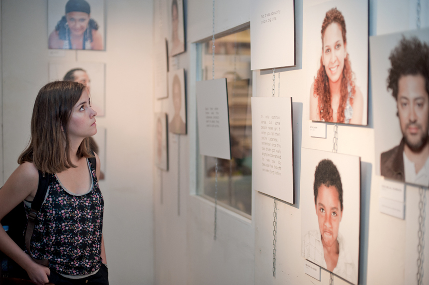 Woman looking at photographs from the Mixed Feelings exhibition at AltCity, September 24, 2014, Beirut. Photo by Marta Bogdanska