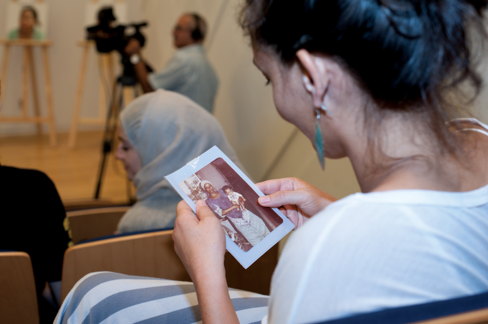 Audience member looks at a picture that was presented to the public during the panel discusion at IFI in AUB, October 8, 2014, Beirut. Photo by Marta Bogdanska
