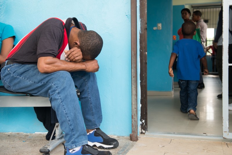 A man from the Dominican Republic bows his head as a child walks into a hospital for treatment. The disease has spread quickly Caribbean-wide. Photo courtesy the Pan American Health Organisation, used under a CC BY-ND 2.0 license.