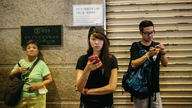 Students gathered in numbers on September 29 outside Sogo Department store in Hong Kong's Causeway Bay to continue the fight for democracy in what being called the Umbrella Revolution. Photo by Pete Walker. Copyright Demotix