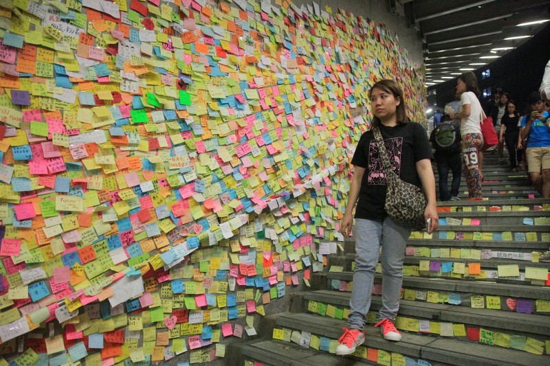 Lennon Wall covered with colorful post-it stickers. Photo taken by Au Kalun