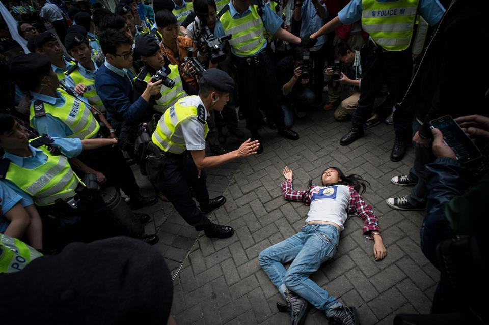 Rayman's photo of a protest incident on 8 of December 2013 has won the Best online Photojournalism Award. A female protester dashed out to the road with an attempt to stop the Chief Executive Leung Chun-ying's vehicle a district-level consultation meeting on the government annual budgetary report. The police carried her away and dropped her on the ground in the process. CC: AT-NC