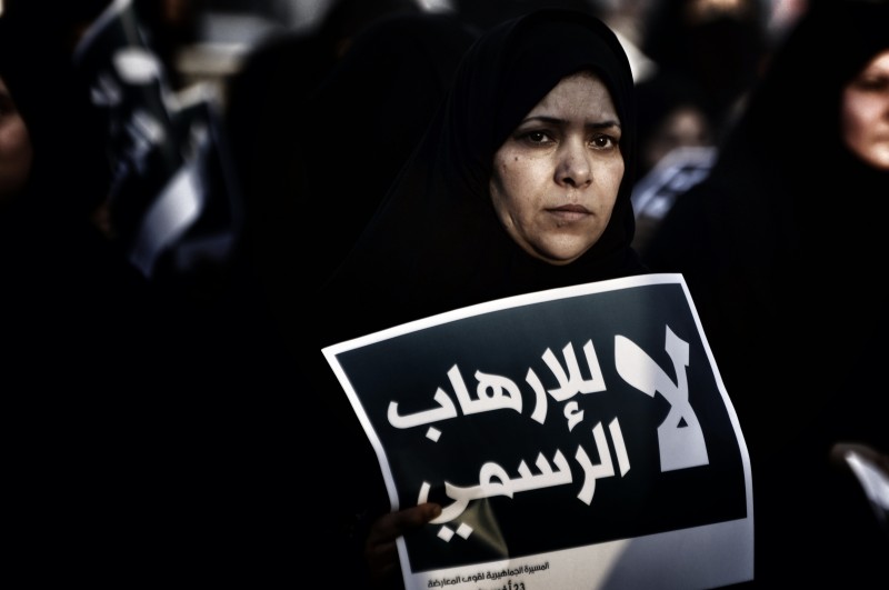 A protester in Bahrain holds a sign that reads: "No to the state-sponsored terrorism, Bahrain is a gulf state that is witnessing the third year of an uprising led by the majority Shia population. Photograph by Hussain Altareef. Copyright: Demotix