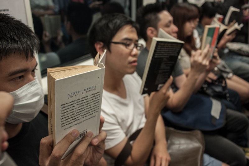 Activists reading books on BTS sky train as a protest against coup. Photo by Yostorn Triyos, Copyright @Demotix (6/13/2014)