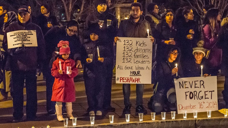 Two hundred people gathered in front of the CNN Center in Atlanta [USA] for a candlelight vigil to honor victims killed during a Taliban attack on a school in Peshawar, Pakistan. Image by Steve Eberherdt Copyright Demotix (17/12/2014)