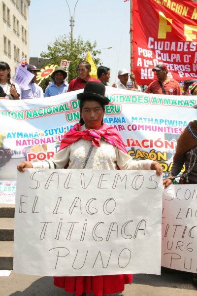 "Let's Save Lake Titicaca" reads a banner held by a woman traveling from the Andes region (border between Peru and Bolivia) calling for action to safeguard the largest lake in Latin America. Photo credit: Hoda Baraka  