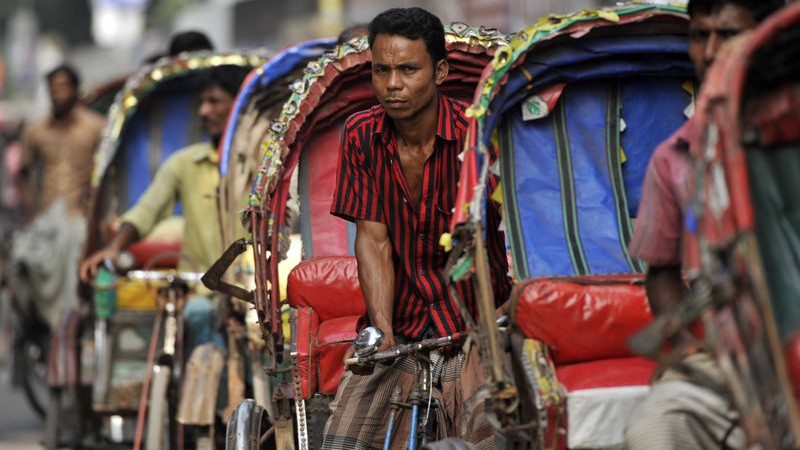 Rickshaws are the main means of transportation in Dhaka. Most of them send money to their rural home via mobile banking. Image by Mohammad Asad. Copyright Demotix (6/11/2013)  