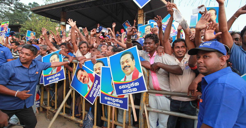 Supporters of Sri Lankan President Mahinda Rajapaksa cheer during an election campaign rally in Palmadulla, Sri Lanka. Image by Chamila Karunarathne. Copyright Demotix (3/1/2015)