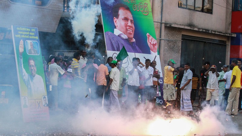 Supporters of Sri Lanka's main opposition presidential candidate Maithripala Sirisena burst firecrackers at the end of voting in the presidential election in Colombo. Image by Chamila Karunarathne. Copyright Demotix (8/1/2015)