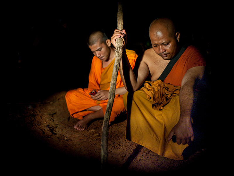 Monks in Cambodia rest during a 25km night march through the jungle to voice their anger over environmental destruction in their country. Photo by photojournalist and Flickr user Luc Forsyth. CC-BY-NC-SA 2.0