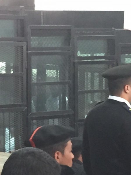 Alaa Abdel Fattah in a cage at his hearing today. Photograph shared by @amirahoweidy on Twitter