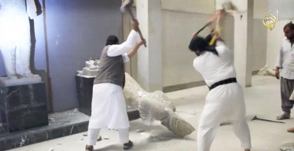 ISIS militants are seen destroying sculptures dating back 3,000 years at a museum in Mosul, Iraq. Photograph shared by @Joyce_Karam on Twitter
