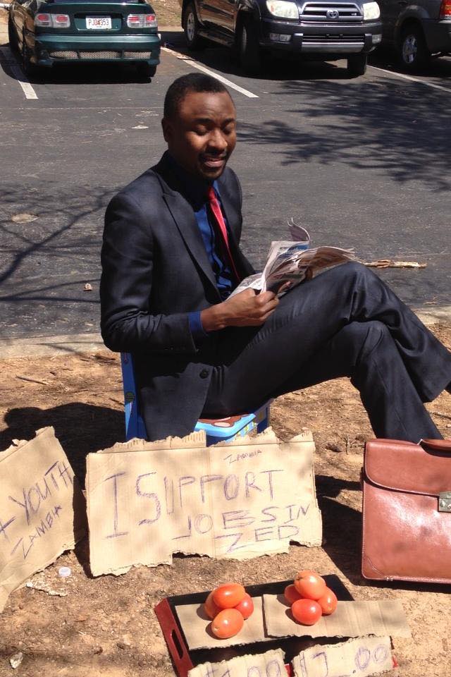 George Mtonga, a US-based Zambian investment banker "selling tomatoes" in support of jobless graduates in Zambia. Photo used with permission from Zambian Watchdog. 