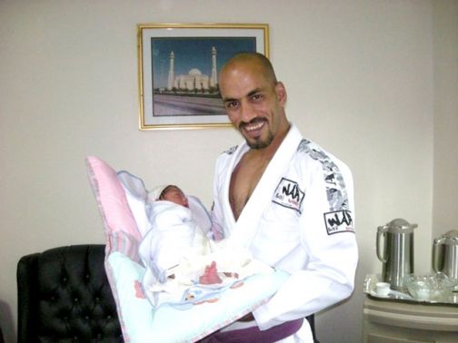 الحائز على الميدالية الذهبية في الجيوجيتسو البرازيلي محمد ميرزا حاملًا طفله جبرائيل