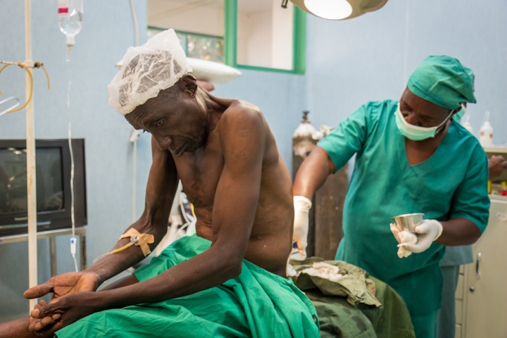 A patient is prepped for surgery to repair a hernia at the Hospital Rural de Chokwe. Before Mozambique began training non-doctors to do surgery, according to the former Health Minister, people were dying from things like miscarriages or getting shot in the leg. Credit: Bridget Huber. Published with PRI's permission