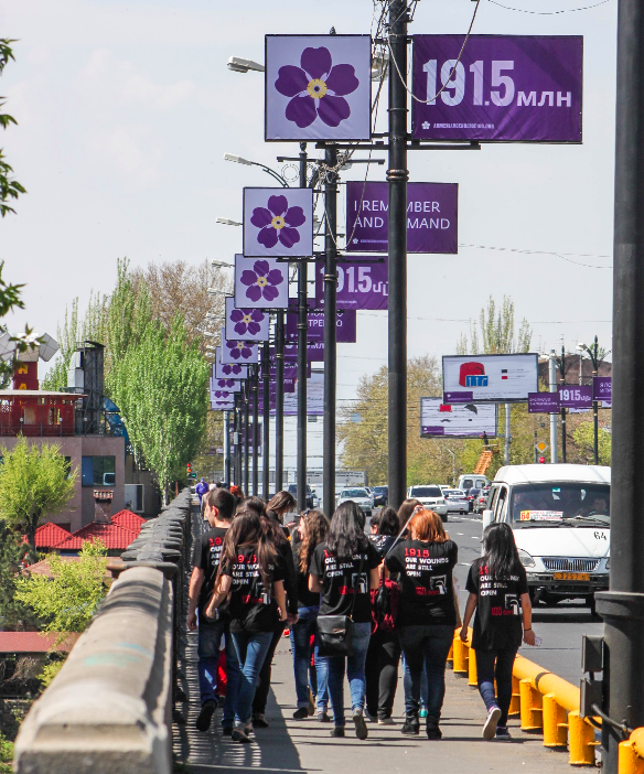 Armenian students walking towards Genocide Museum, surrounded by the Centennial emblem. Photo taken by myself.