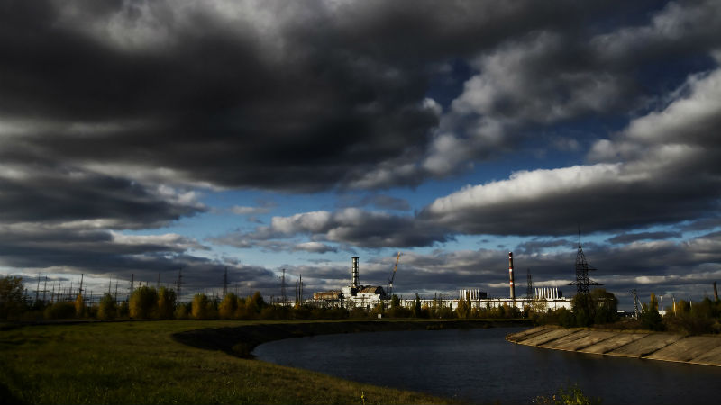 Chernobyl reactor #4 seen from across the man-made cooling river, Ukraine, in 2013. Image by Guy Corbishley from Demotix.