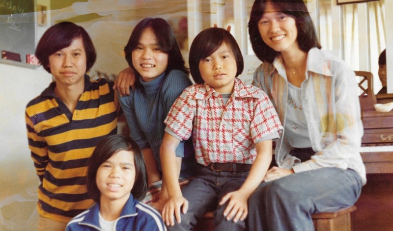 The Truong family arrived to the United States not long after fleeing Vietnam in 1975, when the then-capital of South Vietnam, Saigon, fell to the North Vietnamese army. Thu-Thuy Truong, far right, places bunny ears above her brother, Sy. Credit: Courtesy of Thu-Thuy Truong. Published with PRI's permission